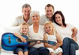 Portrait of family playing guitar at home