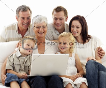 Happy family using a laptop in living-room