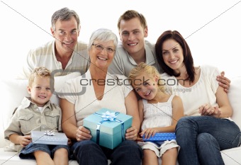 Family giving a present to grandmother