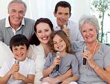Portrait of family singing in living-room