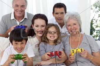 Grandparents, parents and children playing video games