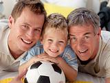 Portrait of smiling son, father and grandfather on floor