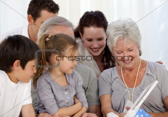 Family giving a present to the grandmother