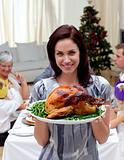 Woman showing to the camera Christmas turkey