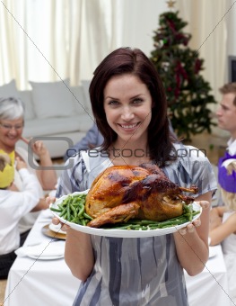 Woman showing to the camera Christmas turkey