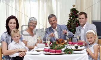 Family eating turkey in Christmas Eve Dinner