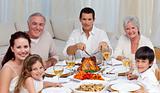 Family eating turkey and vegetables in a celebration meal