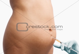 Female mid section being shot for liposuction process