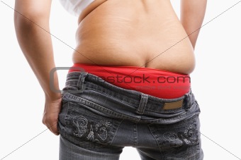 Back side of fat woman trying to wear tight jeans 