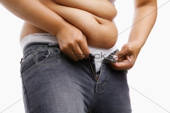 Fat woman trying to put on her tight jeans
