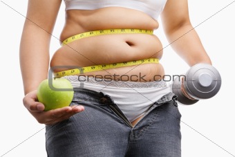 fat woman with unzup jeans holding apple and weight on each hand