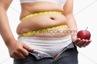 fat woman with unzip jeans holding apple