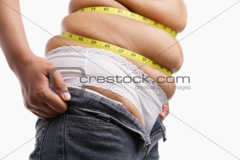 Fat woman trying to wear tight jeans from side