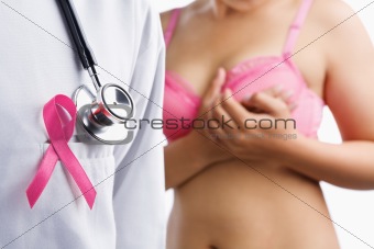 Doctor with pink badge and woman on bra
