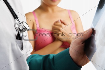 Doctor examine xray slide with nervous woman waiting