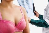 Doctor examine xray with woman on pink bra
