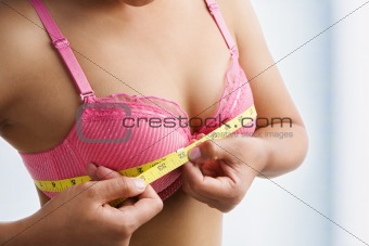 Woman measuring breast size