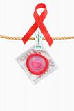 Condom hanging with red ribbon over white background