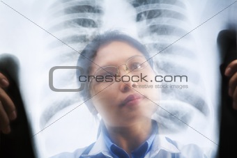 Asian female doctor busy working on x-ray result