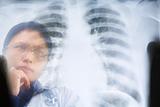 Asian female doctor busy working on x-ray result