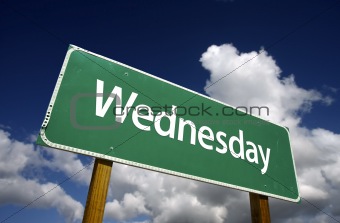 Wednesday Green Road Sign with dramatic blue sky and clouds - Days of the Week Series.