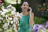 Young Woman in Garden With Cell Phone