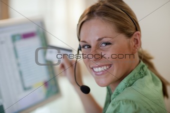 Young Woman With Headset and Credit Card