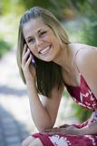 Smiling Woman Outdoors with Cell Phone