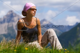 Young woman sitting on a hill