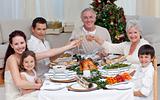 Family drinking a toast in a Christmas dinner