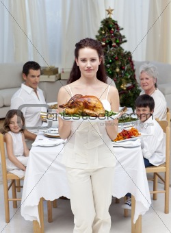 Mother showing turkey for Christmas dinner
