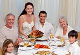 Family eating turkey in a dinner