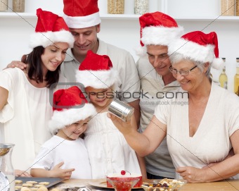 Happy family baking Christmas cakes