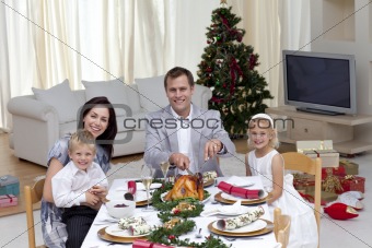 Family celebrating Christmas dinner with turkey