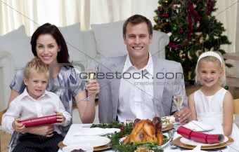 Parents toasting with champagne in Christmas dinner