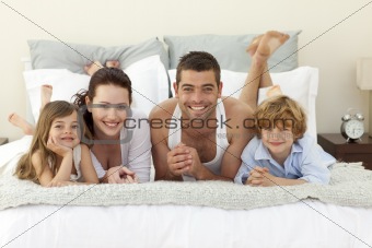 Family lying in bed with pyjamas