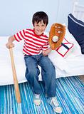 Little boy playing baseball in bed