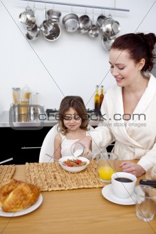 Daughter and mother having breakfast 