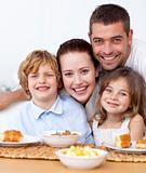 Portrait of happy family having breakfast