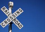 Rail Road Crossing Sign Against a Clear Blue Sky