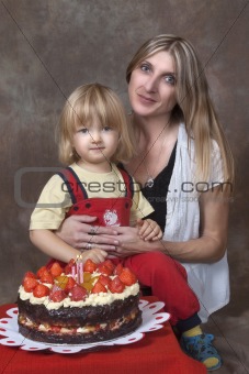 mother and son with birthday cake