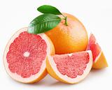 Grapefruits and segments with a leaves on a white background