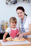 Mother and daughter baking biscuits in the kitchen