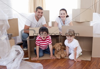 Family in new house playing with boxes