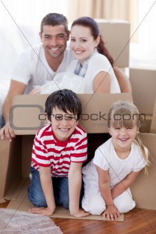 Family moving house playing with boxes