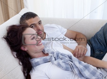 Couple lying on sofa
