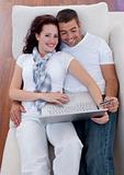 Couple buying online with laptop and credit card