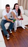 Couple on sofa playing video games