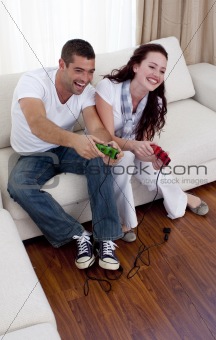 Couple playing video games in living-room