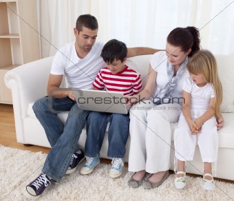 Family at home using a laptop
